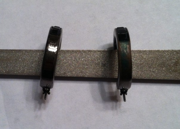 The back of the black hoop I know I pulled out of the jewelry box, left; the other, right.